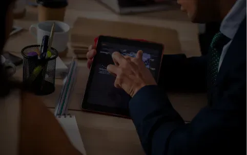 A man presenting data on a tablet